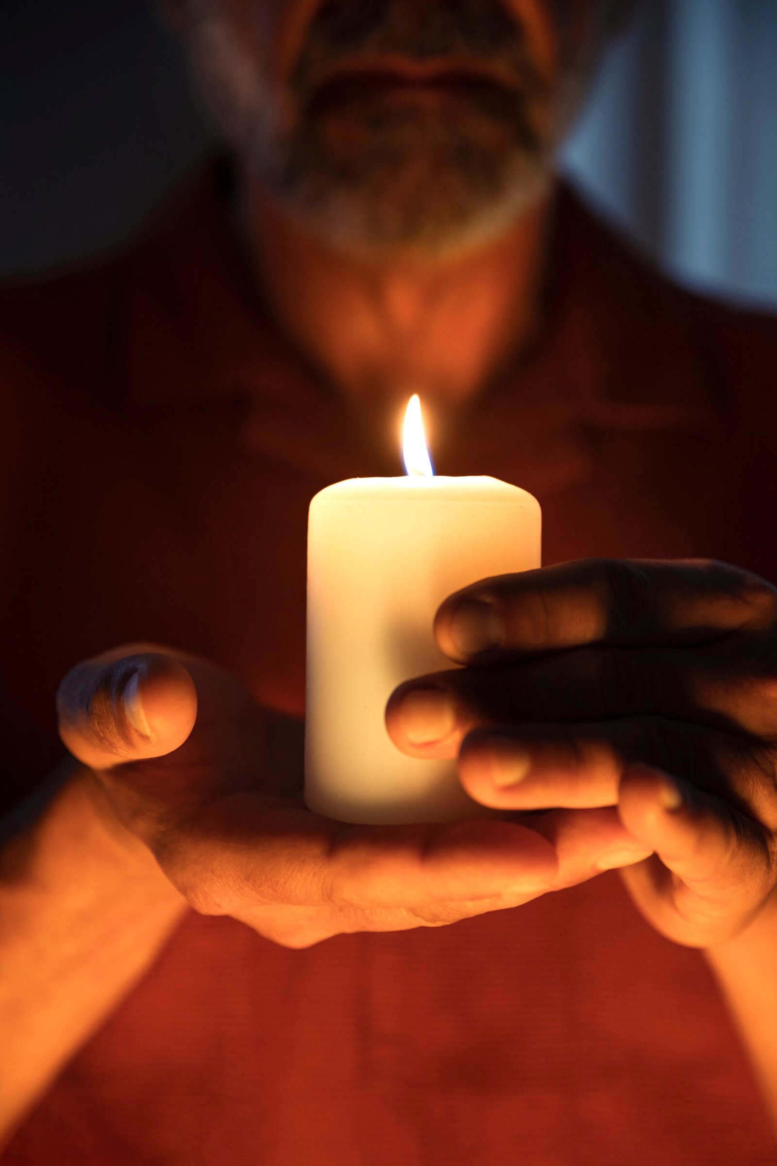 front-view-senior-man-holding-candle